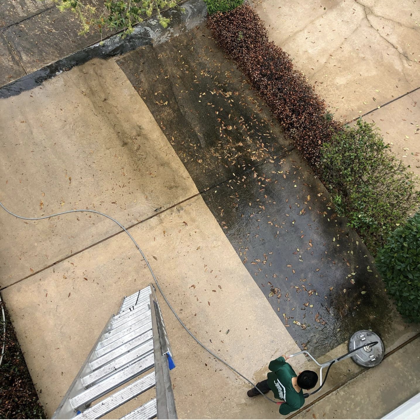 TruShine technician using a surface cleaner on a Houston concrete walkway