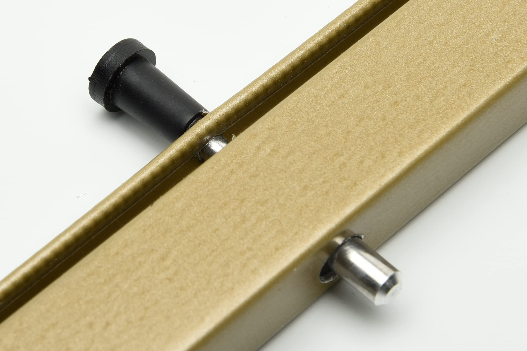 Close-up of a bronze window screen frame with plunger pin hardware